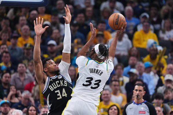 Indiana Pacers center Myles Turner (33) shoots over Milwaukee Bucks forward Giannis Antetokounmpo (34) during the first half of a first-round NBA basketball playoff game in Indianapolis, Tuesday, April 22, 2025. (AP Photo/Michael Conroy)