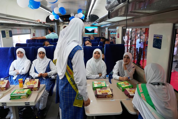 passengers get refreshments inside Vande Bharat Express train which is soon to be inaugurated to run between Srinagar and Katra, in Srinagar, Indian controlled Kashmir, Friday, June 6, 2025. (AP Photo/Dar Yasin)