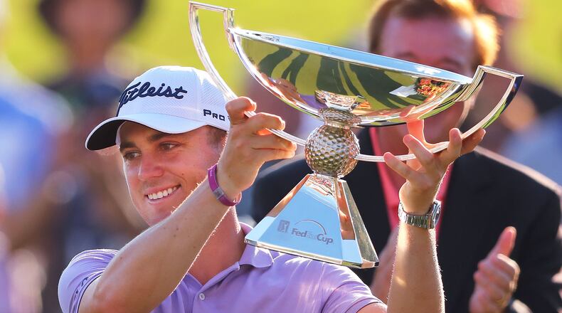 Justin Thomas is presented the FedEx Cup on the 18th green at the conclusion of the Tour Championship at East Lake Golf Club on Sunday, Sept. 24, 2017, in Atlanta. Curtis Compton/ccompton@ajc.com