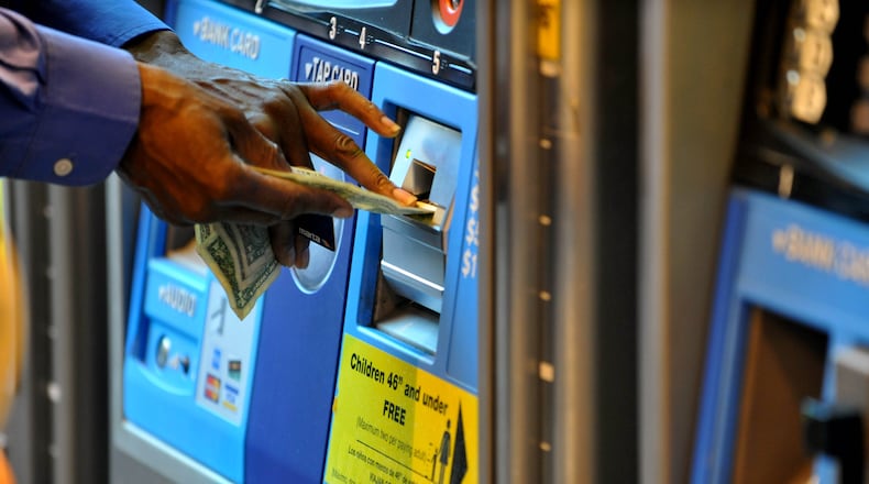 Patrons using fare machines at the Hartsfield Jackson International Airport MARTA station on Tuesday September 4, 2012. KENT D. JOHNSON / KDJOHNSON@AJC.COM