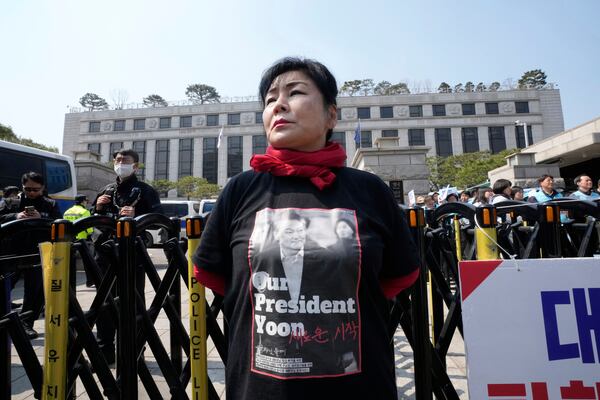 A member of ruling People Power Party stands against impeachment of impeached South Korean President Yoon Suk Yeol in front of the Constitutional Court in Seoul, South Korea, Tuesday, April 1, 2025. (AP Photo/Ahn Young-joon)