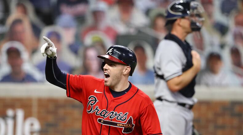 N.Y. Yankees with catcher Erik Kratz (background) looks on as Braves first baseman Freddie Freeman celebrates hitting a two-run homer during the sixth inning of the second game of a double header Wednesday, Aug. 26, 2020, at Truist Park in Atlanta. Freeman's shot proved to be the game winner of 2-1 victory as Atlanta swept the Yankees. (Curtis Compton ccompton@ajc.com)