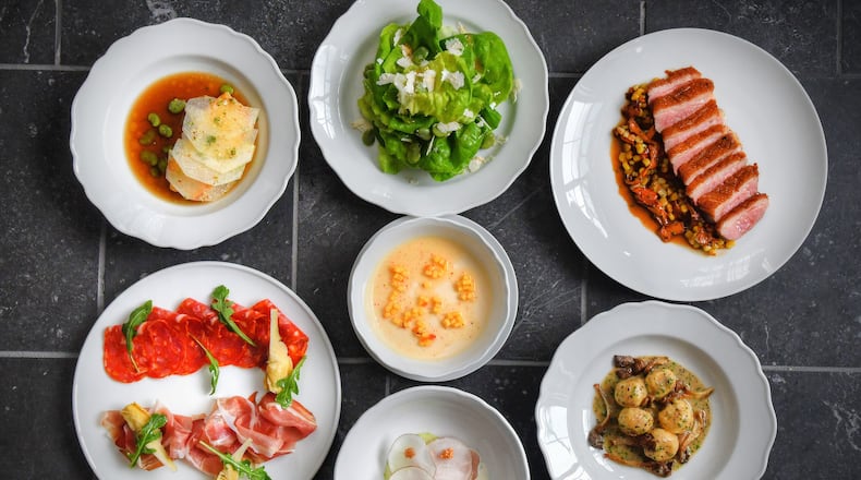 Lucian Books and Wine executive chef Brian Hendrickson strives to make food that’s elemental and beautiful. Lucian's offerings include (clockwise starting at upper left) black bass with kohlrabi and mushroom broth; Gem lettuces with fava beans and ricotta salata; roast duck with chanterelles and corn; ricotta gnudi sauteed with oyster mushrooms and truffle beurre monté; raw hamachi with black radish and cucumber; speck, schiacciata, and artichokes a la grecque, and peach panna cotta (center). (Chris Hunt for The Atlanta Journal-Constitution)