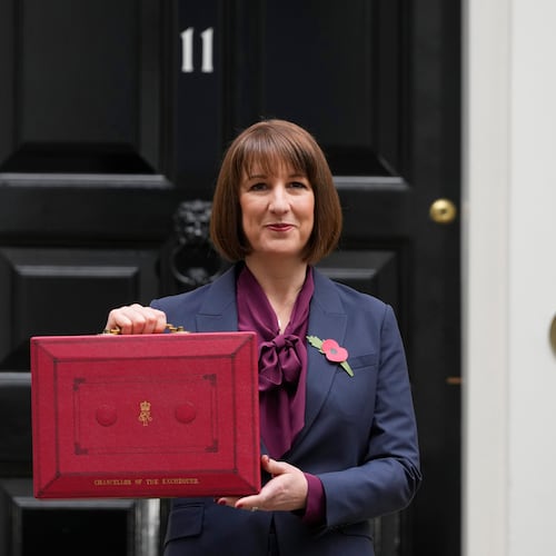 FILE - Britain's Chancellor of the Exchequer, Rachel Reeves, holds up the traditional red ministerial box containing her budget speech, as she poses for the media outside No 11 Downing Street, before departing to the House of Commons to deliver the budget in London, Wednesday, Oct. 30, 2024. (AP Photo/Kirsty Wigglesworth, File)