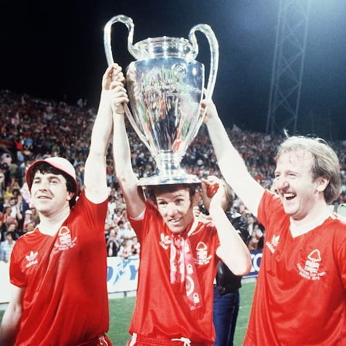 FILE - Nottingham Forest's John Robertson, left, Ian Bowyer, center, and Kenny Burns, right, carry the European Cup in triumph after their 1-0 win against Malmo FF in Munich, Germany, May 30, 1979. (AP Photo, File)