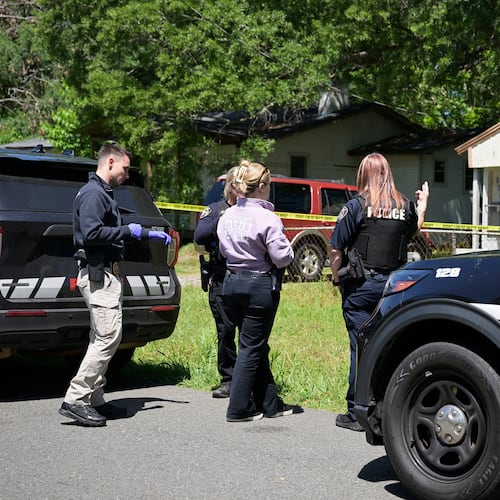 Police gather in front of a house on Harrison Street near Bernstein Avenue, in Shreveport, La., as they investigate a mass shooting, Sunday, April 19, 2026. (Jill Pickett/The Times-Picayune/The New Orleans Advocate via AP)