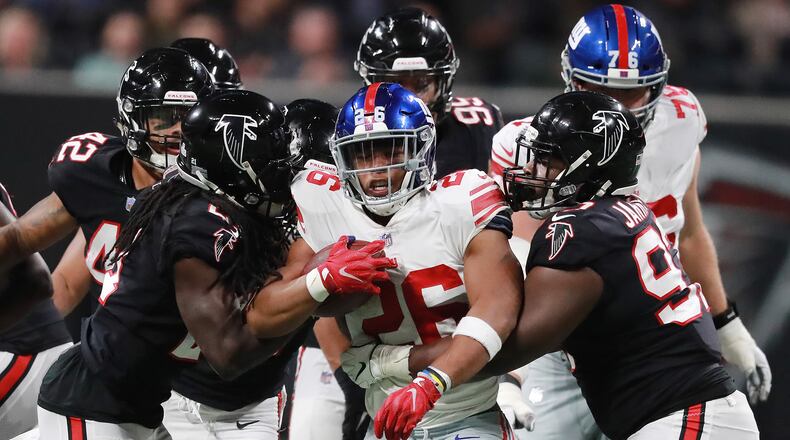 The Falcons D, here making life uncomfortable for New York Giants running back Saquon Barkley, will get no reinforcement through the trade market. (Curtis Compton/ccompton@ajc.com)