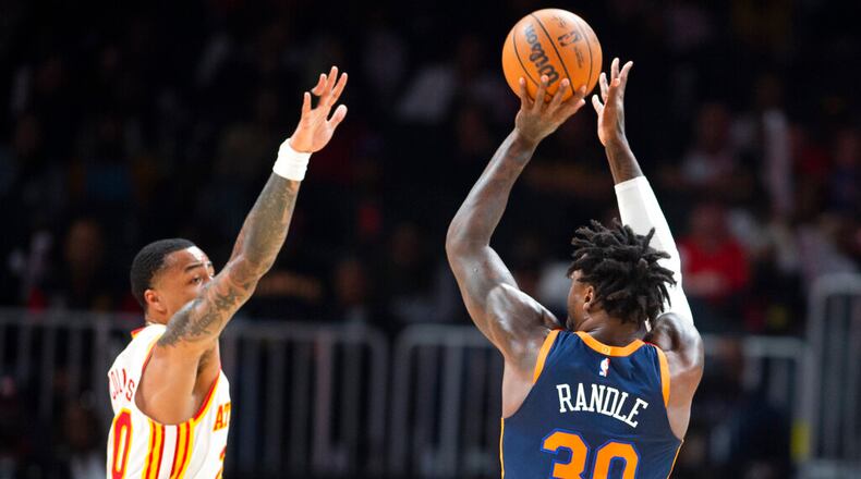 New York Knicks forward Julius Randle shoots over Atlanta Hawks forward John Collins during the first half of an NBA basketball game, Wednesday, Feb. 15, 2023, in Atlanta. (AP Photo/Hakim Wright Sr.)