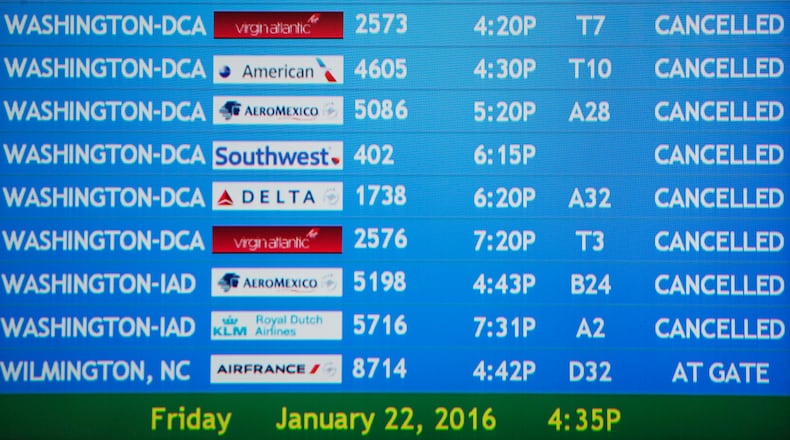 A display board shows cancelled flights at Hartsfield–Jackson Atlanta International Airport Friday, Jan. 22, 2016, in Atlanta. Snow flurries fell Friday afternoon in downtown-midtown Atlanta. National Weather Service meteorologist Matt Sena says around an inch is expected to accumulate overnight. (AP Photo/David Goldman)