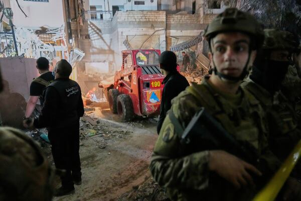 Rescue workers and Lebanese army soldiers work at the site of an Israeli targeted strike on an apartment building in Dahiyeh, in the southern suburb of Beirut, Lebanon, early Tuesday, April 1, 2025.(AP Photo/Hussein Malla)