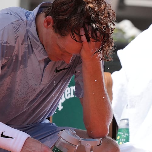 Jannik Sinner of Italy reacts as he cools himself with the water during a break at the second round men's singles tennis match against Juan Manuel Cerundolo of Argentina at the French Open tennis tournament in Paris, Thursday, May 28, 2026, as temperature rises up to 33 C (91 F). (AP Photo/Thibault Camus)
