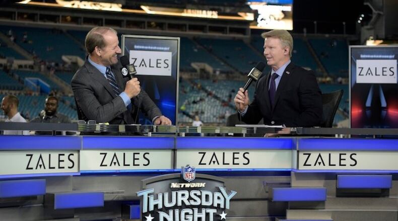 FILE - In this Nov. 19, 2015, file photo, Thursday Night Football sportscasters Bill Cowher, left, and Phil Simms broadcast from the set on the field before an NFL football game between the Jacksonville Jaguars and the Tennessee Titans in Jacksonville, Fla. Every NFL football game will be shown live online this 2017-18 season, but that doesn't mean you can watch. (AP Photo/Phelan M. Ebenhack, File)