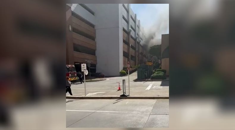 Kennestone's blue parking deck, located at the corner of Tower Road and Church Street, became shrouded in gray smoke just before 11 a.m. Thursday.