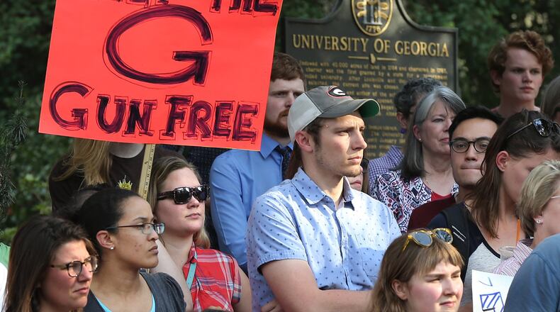 Students, faculty, staff and local residents hold a protest last week at the University of Georgia to oppose a bill to allow the concealed carrying of guns on the state’s public college and university campuses. Curtis Compton/ccompton@ajc.com