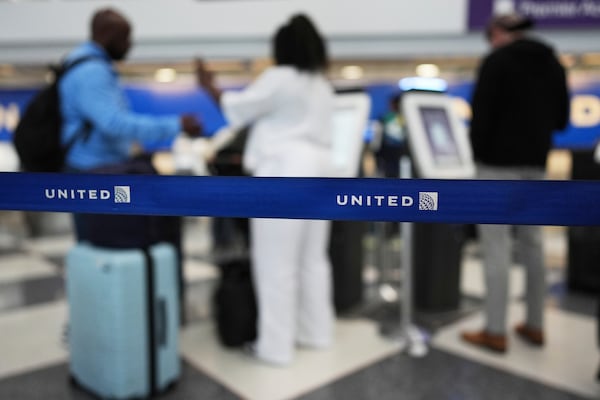 Travelers print out their boarding passes at kiosks inside of O'Hare International Airport in Chicago, Friday, May 23, 2025. (AP Photo/Nam Y. Huh)