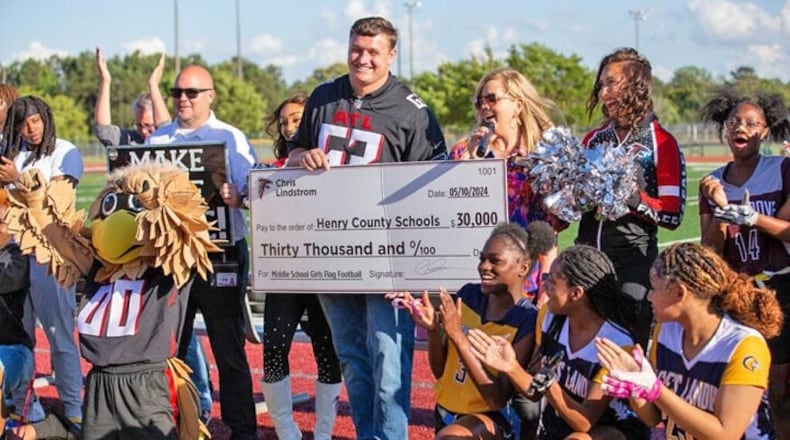 Atlanta Falcons player Chris Lindstrom - along with Falcons cheerleaders, mascot Freddie Falcon, and other Falcons representatives -  presented a $30,000 donation to Henry County Schools to fund middle school girls flag football. (Photo Courtesy of Toni Lee)