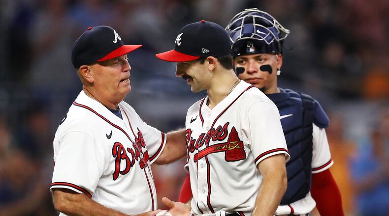 Braves manager Brian Snitker gives starting pitcher Spencer Strider a pat on the back as he removes him from an August game after a strong outing from the rookie. “Curtis Compton / Curtis Compton@ajc.com
