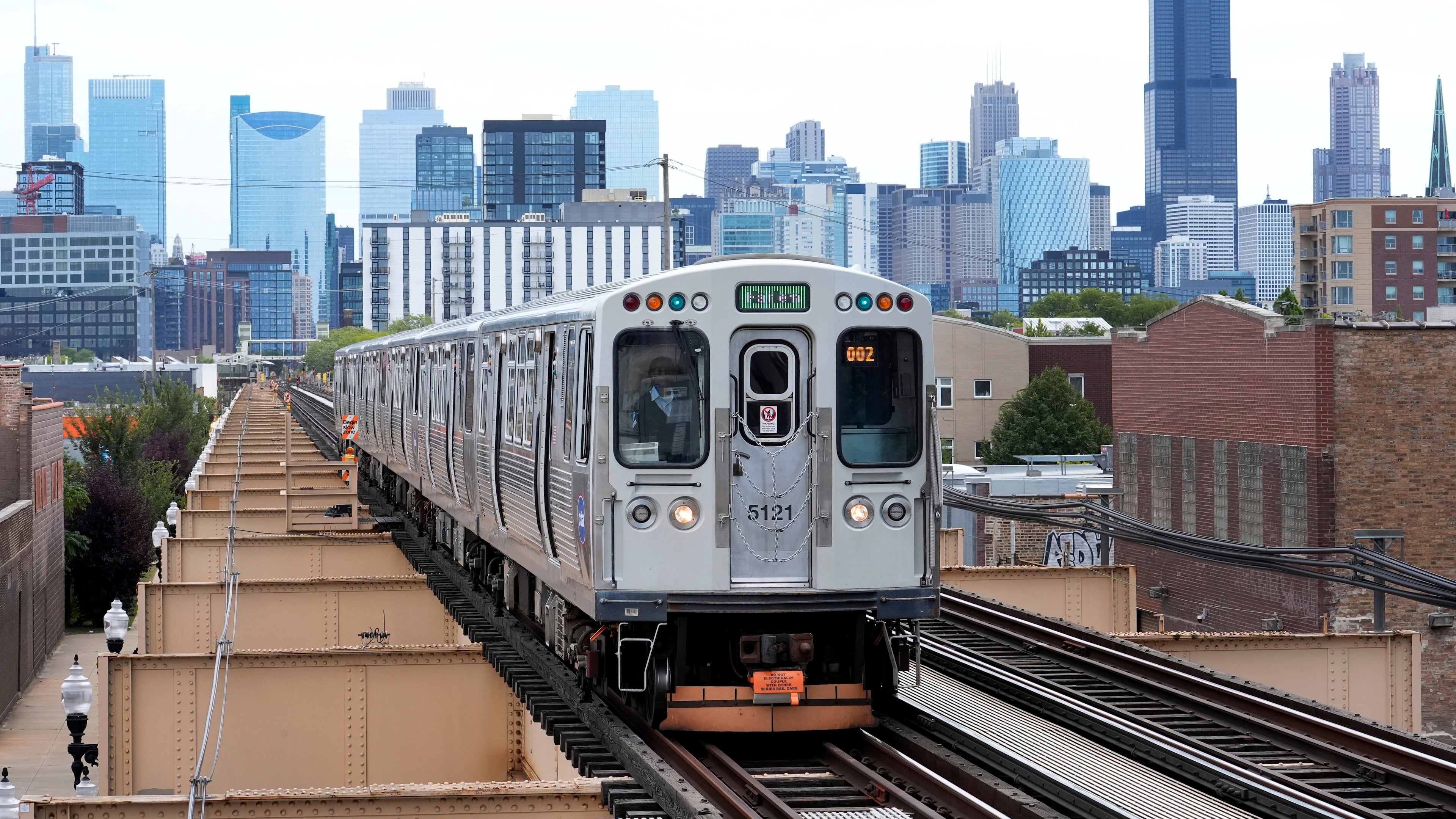 FILE - A Chicago Transit Authority train pulls into the new Damen Ave. station just two blocks from the United Center, Aug. 12, 2024. (AP Photo/Charles Rex Arbogast, File)