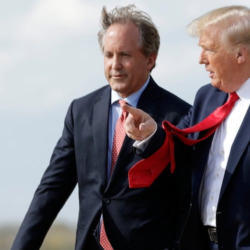 FILE - President Donald Trump walks with Texas Attorney General Ken Paxton, left, at Austin-Bergstrom International Airport in Austin, on Wednesday, Nov. 20, 2019. (AP Photo/Evan Vucci, File)
