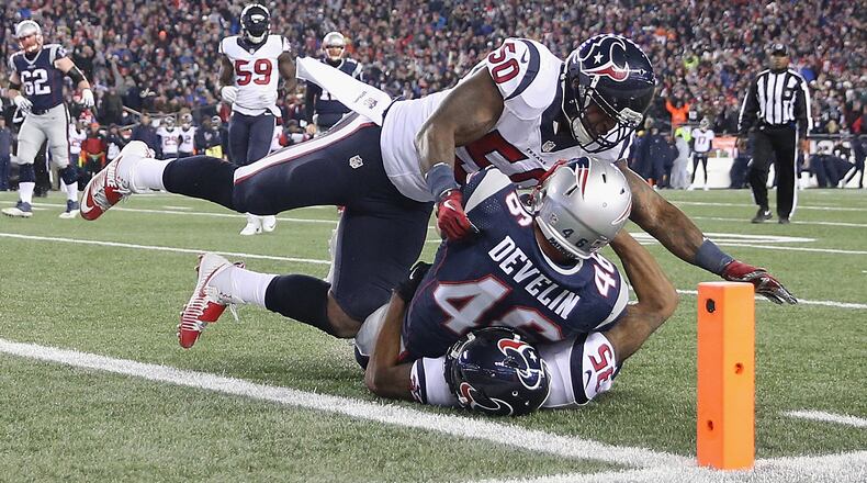 James Develin (46) of the New England Patriots is tackled by Eddie Pleasant (35) and Akeem Dent (50) of the Houston Texans in the first half during the AFC Divisional Playoff Game at Gillette Stadium on January 14, 2017 in Foxboro, Massachusetts.  (Photo by Maddie Meyer/Getty Images)