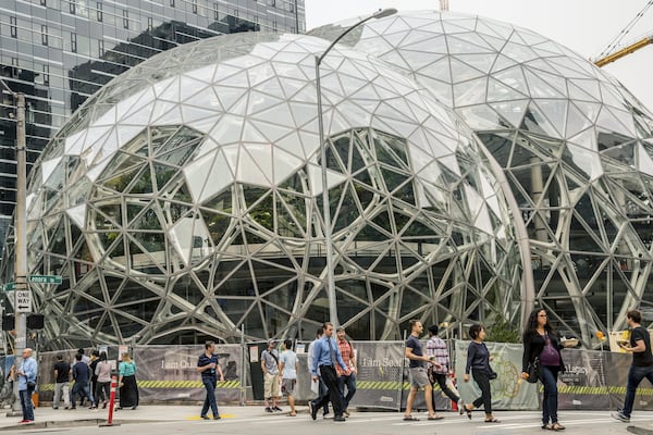 Pedestrians walk past a recently built trio of geodesic domes that are part of the Seattle headquarters for Amazon,. The online retail giant is searching for a second headquarters in North America, a huge new development that would cost as much as $5 billion to build and run, and house as many as 50,000 employees. (Stuart Isett/The New York Times)