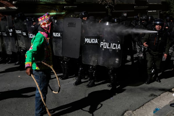 A supporter of former President Evo Morales confronts police during clashes near the offices of the Electoral Tribunal in La Paz, Bolivia, Friday, May 16, 2025. (AP Photo/Juan Karita)
