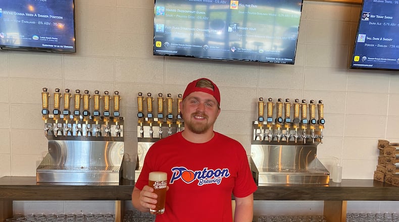 Pontoon Brewing co-owner Sean O’Keefe is shown behind the bar at the new taproom in Tucker known as “The Lodge.” (Bob Townsend for The Atlanta Journal-Constitution)