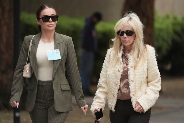 Family members and supporters of Erik and Lyle Menendez, who were sentenced in 1996 to life in prison without the possibility of parole for fatally shooting their parents, leave court after a resentencing hearing in the Menendez case, Thursday, April 17, 2025, in Los Angeles. (AP Photo/Damian Dovarganes)
