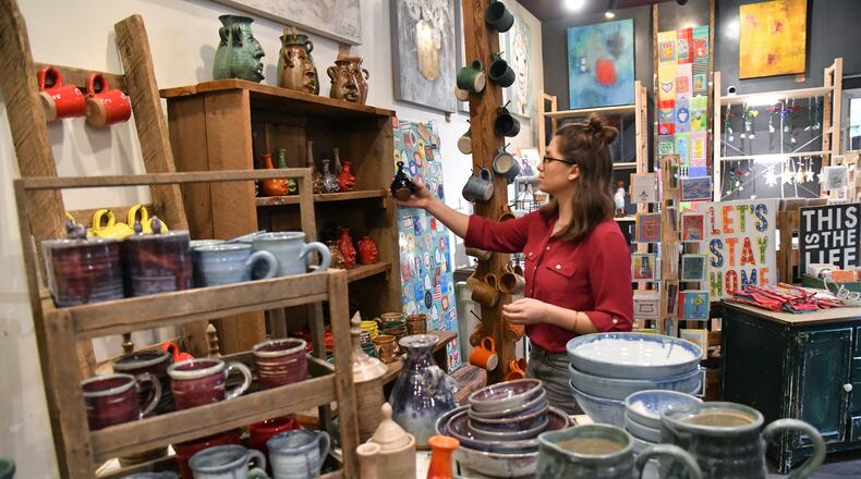 Jocelyn Lion places price tags at Wild Oats and Billy Goats in Decatur on Tuesday, February 18, 2020. (Hyosub Shin / Hyosub.Shin@ajc.com)