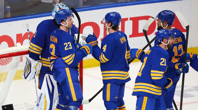 Buffalo Sabres players celebrate victory following the third period in Game 1 of a first-round NHL hockey Stanley Cup playoff series against the Boston Bruins, Sunday, April 19, 2026, in Buffalo, N.Y. (AP Photo/Jeffrey T. Barnes)