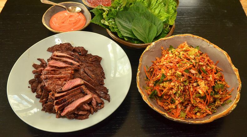 Soy-based marinated beef, Kimchi Slaw, Gochujang Sour Cream and Ssamjang with romaine and perilla leaves await assembly. (Photo by Chris Hunt/Special)