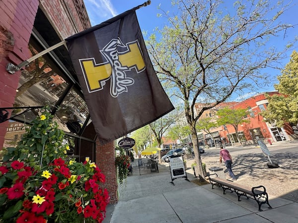 A University of Idaho flag hangs from a storefront in downtown Moscow, Idaho, on Tuesday, July 1, 2025. (AP Photos/Manuel Valdes)