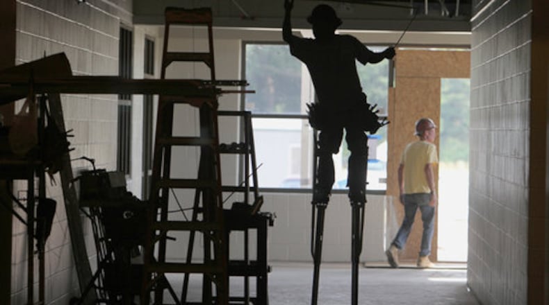 SCHOOL WORK--Evergreen construction and sub-contractor crews work on the ceiling, windows, painting and electrical inside the new elementary school that is scheduled to be completed in the fall. The new building will have 77 classrooms on about 38 acres of land. Cherokee County schools are moving forward with an ELOST vote in November. We take a look at this new elementary school in construction along Hunt Road in Acworth Wednesday, May 25, 2011.