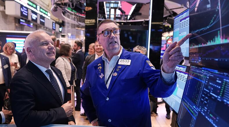 Anders Opedal, President and CEO of Norway's Equinor, left, meets with specialist Patrick King on the floor of the New York Stock Exchange, after he rang the closing bell, Tuesday, June 16, 2026. (AP Photo/Richard Drew)