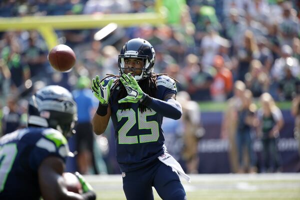 FILE - Seattle Seahawks cornerback Richard Sherman takes part in warmups before an NFL football game against the Denver Broncos, Sunday, Sept. 21, 2014, in Seattle. (AP Photo/Elaine Thompson, File)