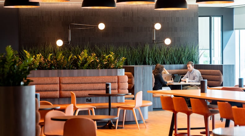 Employees work in a booth at Gas South's new corporate headquarters in Cobb County on Thursday, August 8, 2024. (Seeger Gray / AJC)