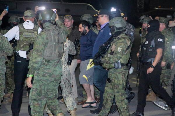 Escorted by soldiers and policemen, Adolfo "Fito" Macias, the leader of the Choneros gang, arrives in Guayaquil, Ecuador, after he was detained by police, Wednesday, June 25, 2025. (AP Photo/Joffre Flores)
