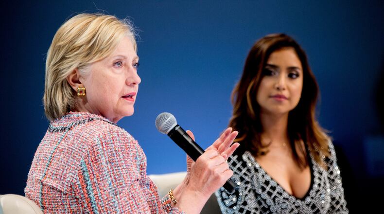 Democratic presidential candidate Hillary Clinton, accompanied by Dulce Candy, right, speaks at a Digital Content Creators Town Hall at the Neuehouse Hollywood in Los Angeles, Tuesday, June 28, 2016. (AP Photo/Andrew Harnik)
