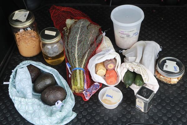 Sonya Shah’s recent shopping trip at the Sevananda Natural Foods Market reflects her zero waste lifestyle: All the containers and bags are reusable for her items that include organic peanut butter in a reused spaghetti sauce jar, hand soap, avocados in a cloth shirt made into a bag, kale, garlic powder, carrots, a can of oregano, black-eyed peas, cucumbers, and rice crackers. CURTIS COMPTON / CCOMPTON@AJC.COM