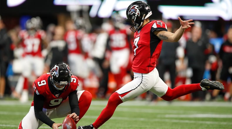 Younghoe Koo  of the Atlanta Falcons kicks a field goal as Ryan Allen  holds in the first half on an NFL game against the Carolina Panthers at Mercedes-Benz Stadium on December 8, 2019 in Atlanta, Georgia. (Photo by Todd Kirkland/Getty Images)