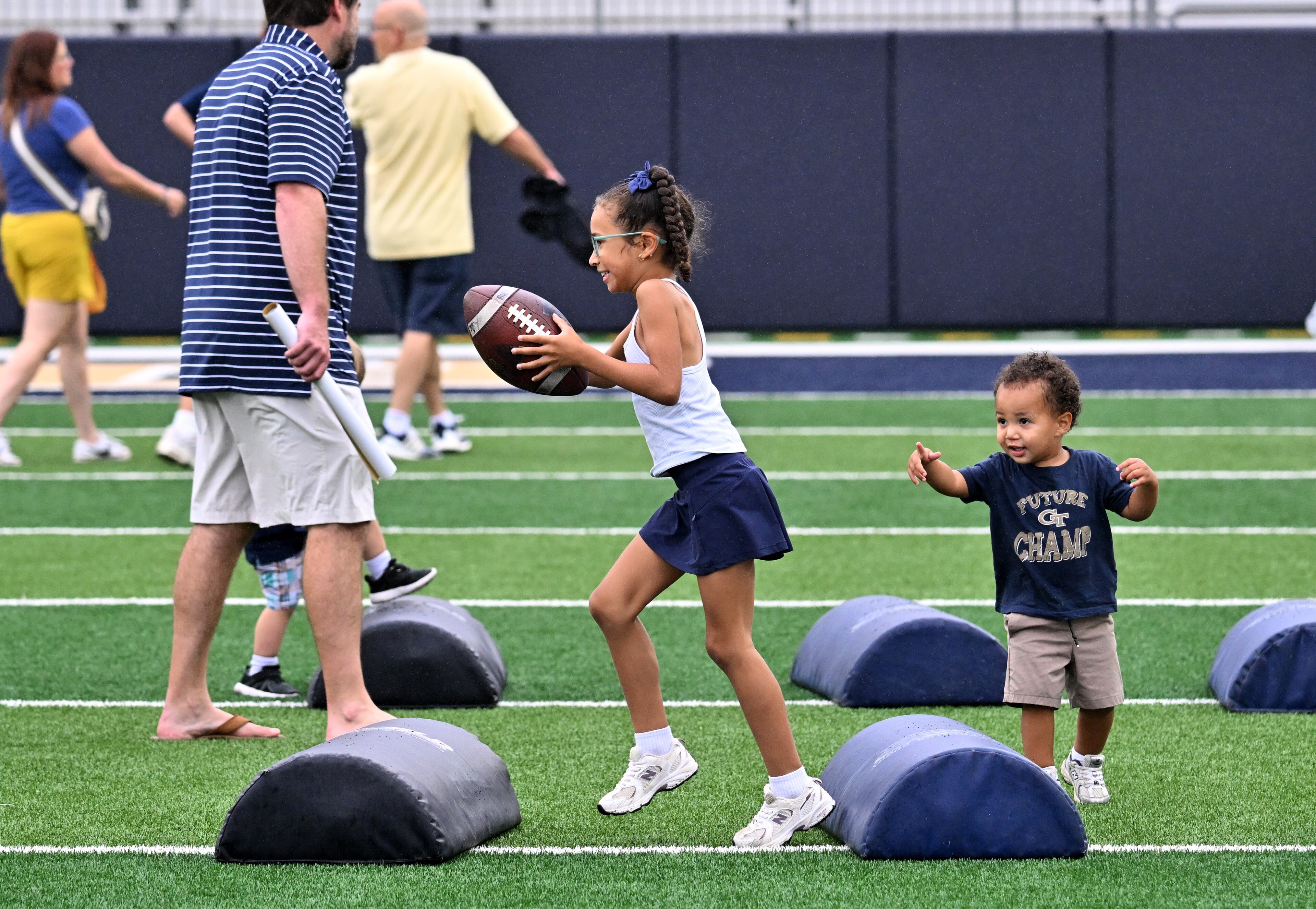 Attendees enjoy a variety of entertaining activities during the annual “First Saturday on The Flats” at Bobby Dodd Stadium, Saturday, August 2, 2025, in Atlanta. The Flats provides Tech fans with the opportunity to engage with their favorite Yellow Jackets ahead of the upcoming 2025 season. The event offers a variety of entertaining activities for the whole family, including a DJ, autograph opportunities, tailgate games and interactive experiences right on the field at Bobby Dodd Stadium. (Hyosub Shin / AJC)