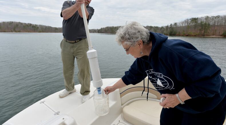 Lake Lanier Association volunteers Bev Nicholls and her husband Denny collect a water sample on Lake Lanier Wednesday March 18, 2015. BRANT SANDERLIN/BSANDERLIN@AJC.COM