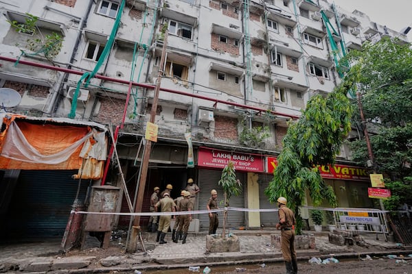 Firefighters inspect a hotel building which caught fire on Tuesday resulting in several deaths, in Kolkata, India, Wednesday, April 30, 2025. (AP Photo/Bikas Das)
