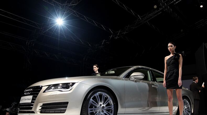 SINGAPORE - MAY 11: People watch on as the new Audi A7 Sportback is unveiled at the Audi Fashion Festival 2011 Gala Night at the Tent@Orchard on May 11, 2011 in Singapore. (Photo by Suhaimi Abdullah/Getty Images for Audi Fashion Festival)