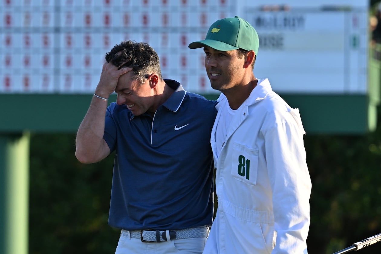 Rory McIlroy celebrates with caddie Harry Diamond, winning the Masters golf tournament with a birdie in the first playoff hole during final round of the Masters golf tournament, at Augusta National Golf Club, Sunday, April 13, 2025, in Augusta, Ga. (Hyosub Shin / AJC)