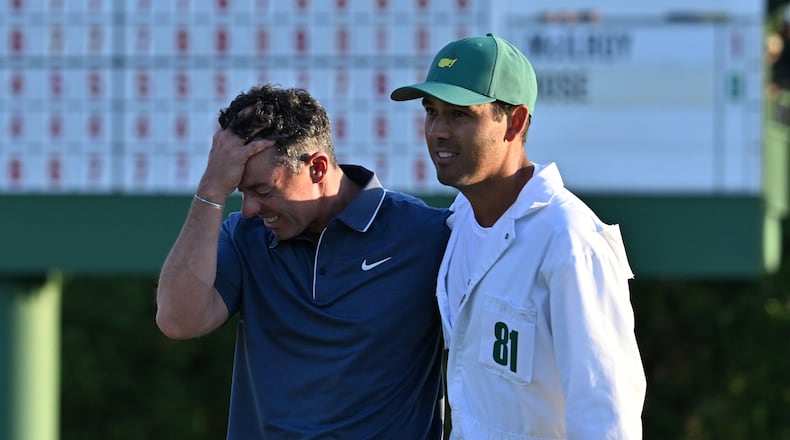 Rory McIlroy celebrates with caddie Harry Diamond, winning the Masters golf tournament with a birdie in the first playoff hole during final round of the Masters golf tournament, at Augusta National Golf Club, Sunday, April 13, 2025, in Augusta, Ga. (Hyosub Shin / AJC)