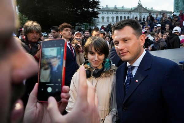 Far-right Confederation party's presidential candidate Sławomir Mentzen poses for a photo with supporters in Saturday,Warsaw, Poland, May 10, 2025. (AP Photo/Czarek Sokolowski)