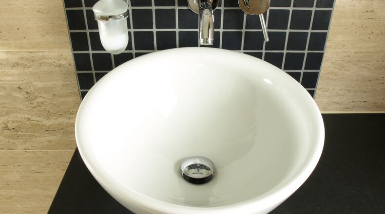 With a beautiful stone vessel sink, the sink itself can be the design centerpiece for the room. (Dreamstime)