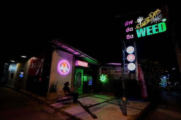 FILE--A customer sits outside a cannabis shop in Kanchanaburi province, west of Bangkok, Thailand, July 16, 2024. (AP Photo/Sakchai Lalit, File)