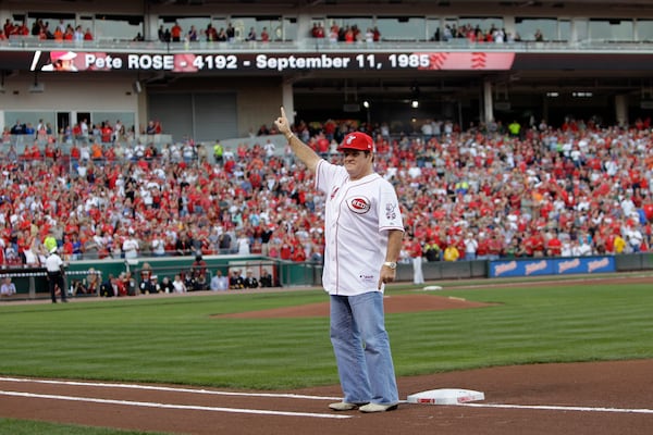FILE - Former Cincinnati Reds great Pete Rose stands on first base as he acknowledges the crowd during ceremonies celebrating the 25th anniversary of Rose breaking Ty Cobb's hit record prior to a baseball game between the Reds and Pittsburgh Pirates, Saturday, Sept. 11, 2010, in Cincinnati. (AP Photo/Al Behrman, File)